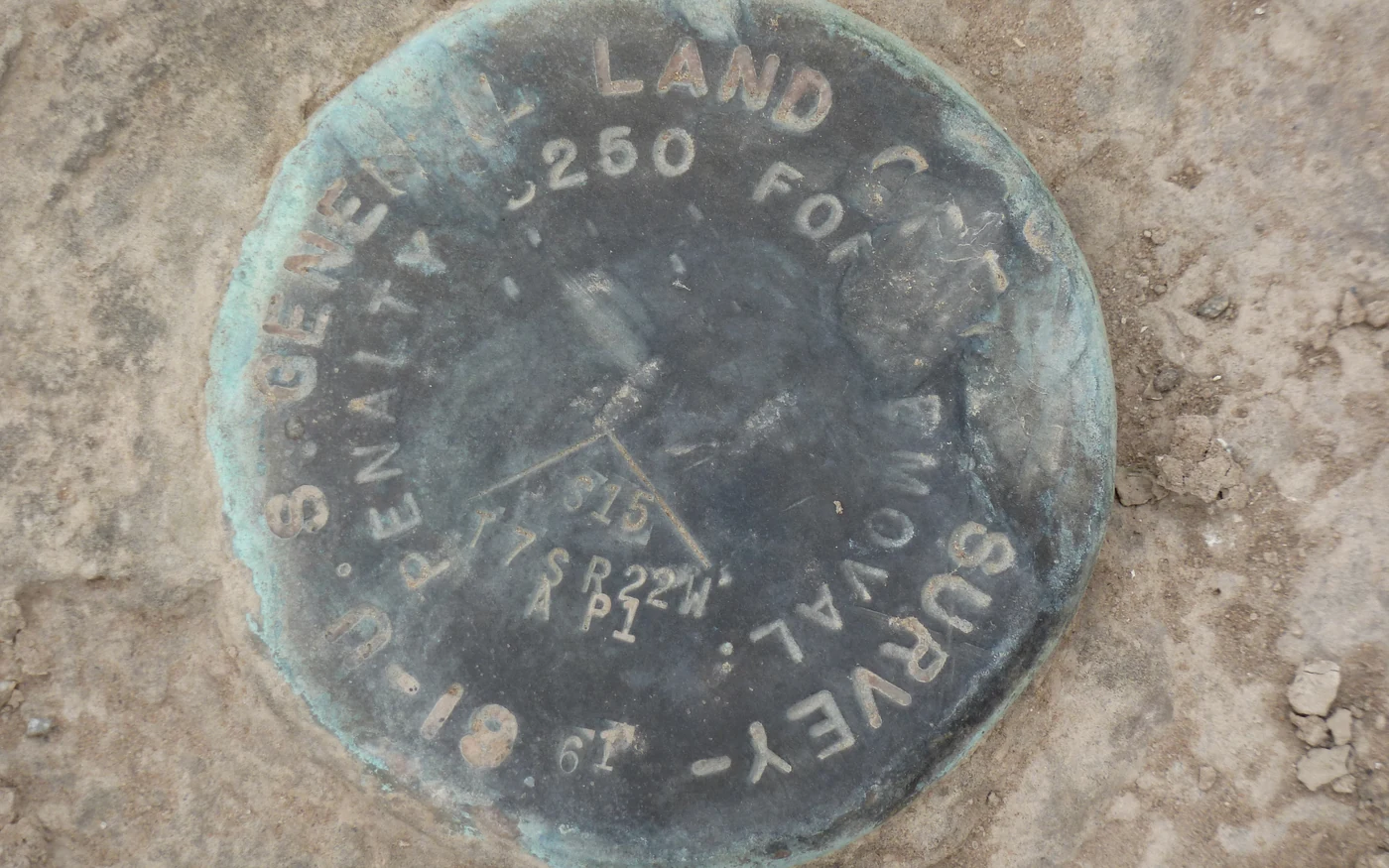 Recovered survey monument marker in the ground